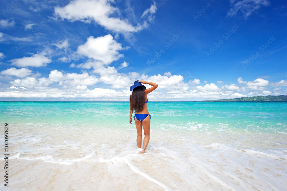 Enjoying freedom. Beautiful woman on beach in summer hat Enjoying freedom. Beautiful woman on beach in summer hat