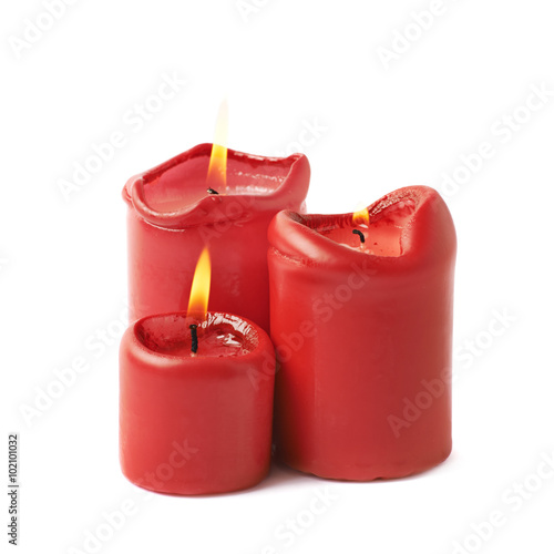 Three burning red candles isolated