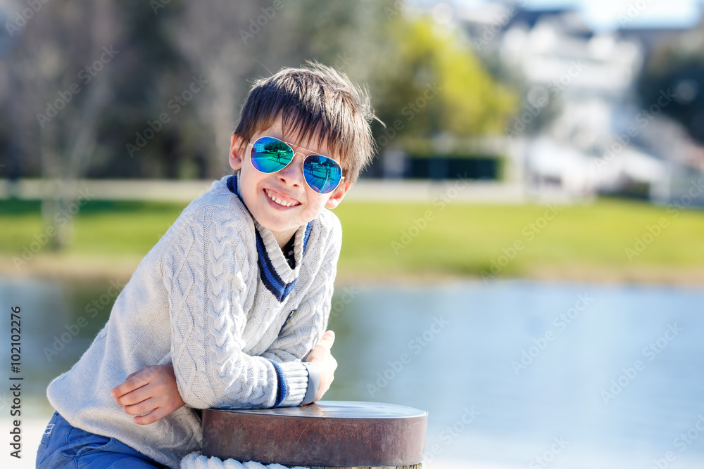 Cheerful little boy having relax outdoors