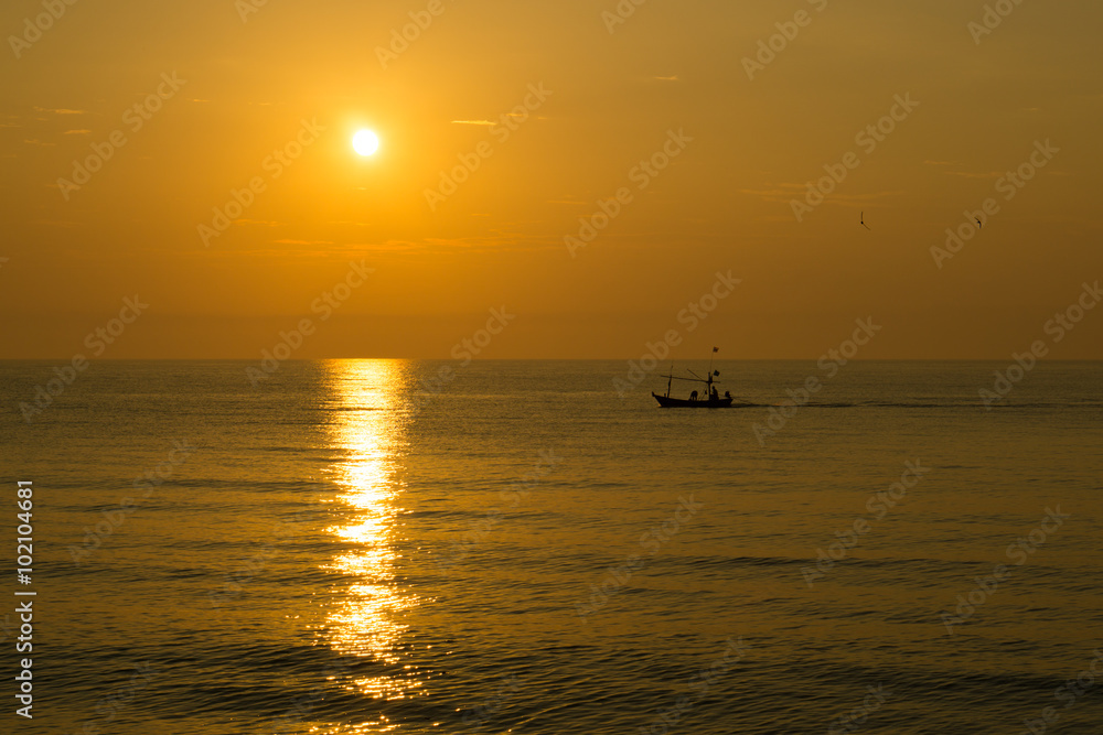 Fisherman on the boat at sunset time