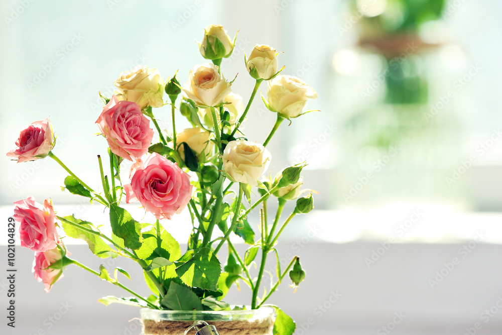 Beautiful spring flowers in vase on window background Beautiful spring flowers in vase on window background