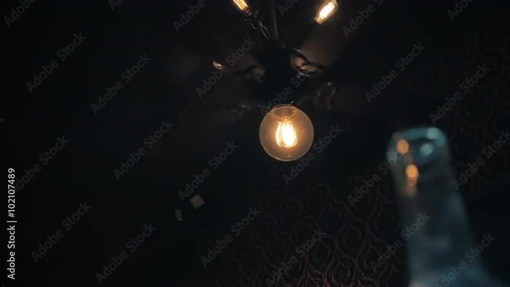 A vintage electric ceiling fan turns slowly in this rather eerie dimly