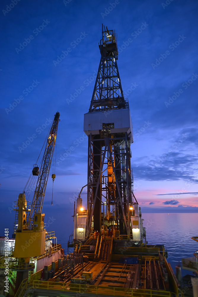 Derrick of jack up oil rig with twilight sky