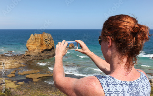 Great Ocean Road Tourist Taking Phone Photo photo