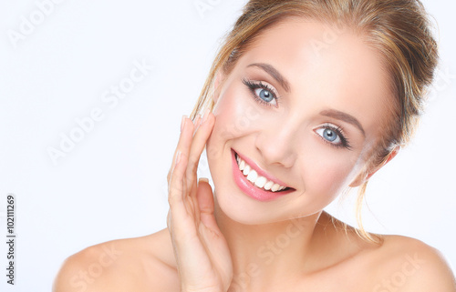 Young woman touching her face isolated on white background