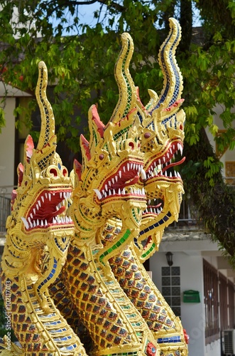 Gold half snake, half-dragons decorating Naga staircase to Wat Wichit Sangkaram, Phuket, Thailand