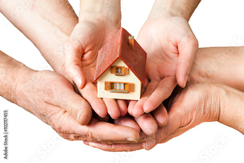 hands holding house