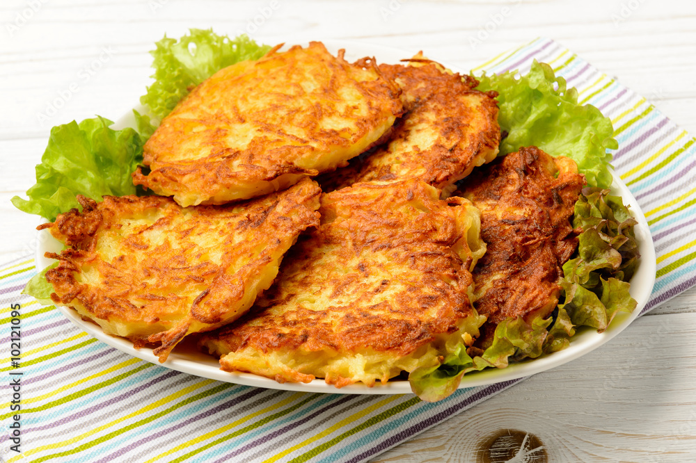 Potato pancakes on white wooden table. Potato pancakes on white wooden table.