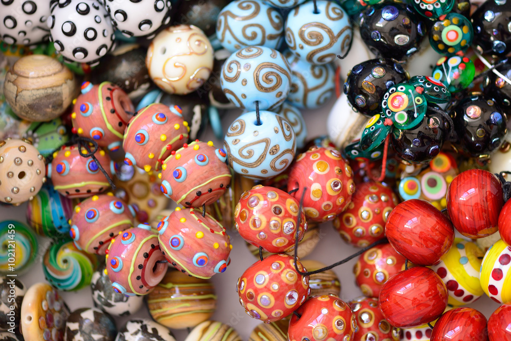 a pile of glass beads of different colors, lampwork