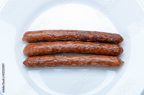 hunting smoked sausage on a white plate closeup
