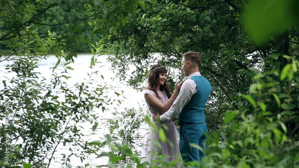 Man and woman, young happy married couple having fun near the lake. Man and woman, young happy married couple having fun near the lake.