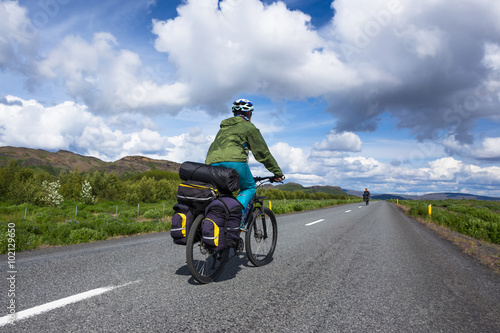Fototapeta Naklejka Na Ścianę i Meble -  Biker rides on road at summer day in Iceland. Travel and sport picture