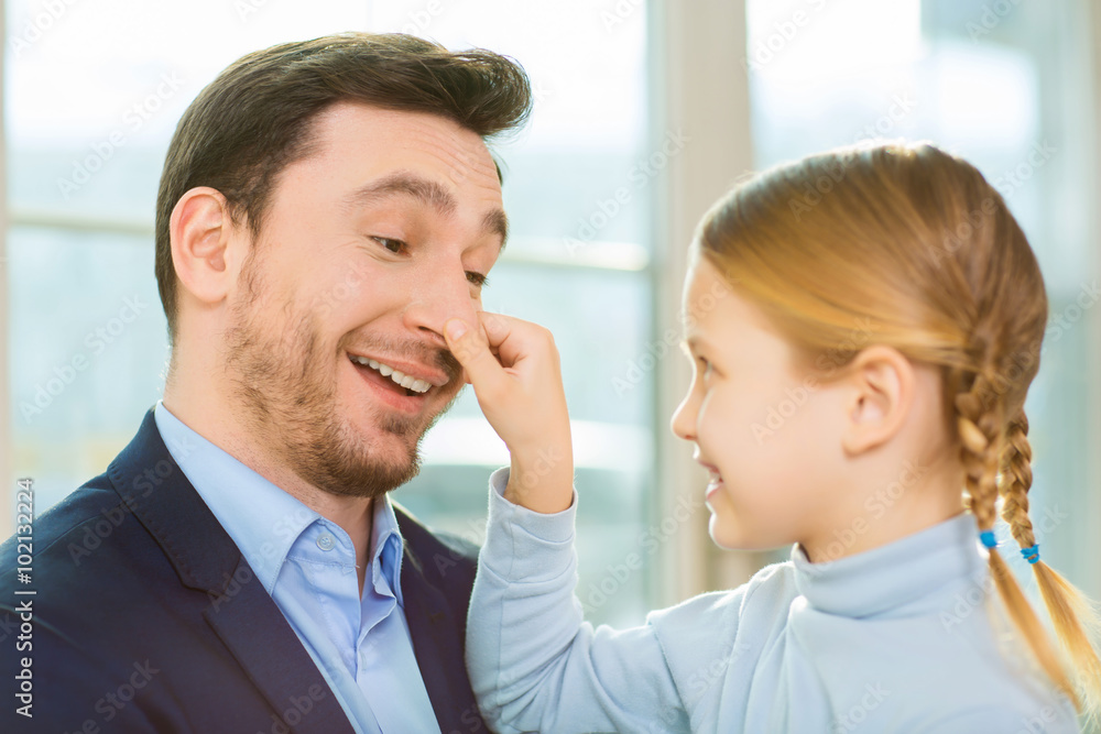 Young cheerful father communicating with daughter. Young cheerful father communicating with daughter.
