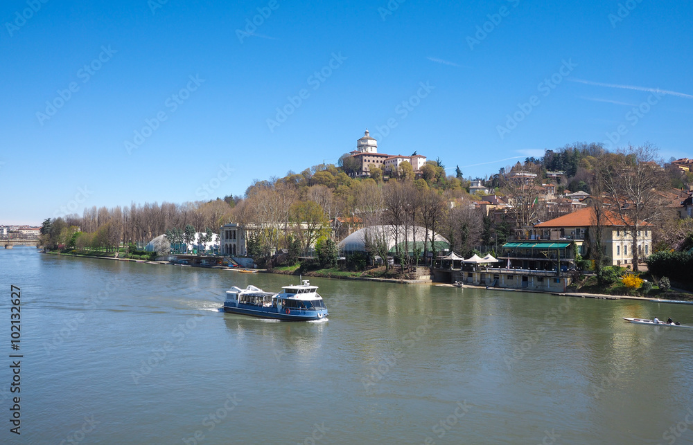 Fototapeta premium Tourist boat on Po river in Turin, Piedmont, Monte dei Cappuccini church in background