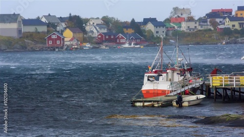 Gusts of storm wind in the Gulf of Reine in Lofoten. Strong wind lifts the water drop above the surface. photo