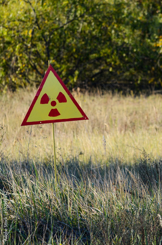 Radiation warning sign on the field near Chernobyl, October 2015