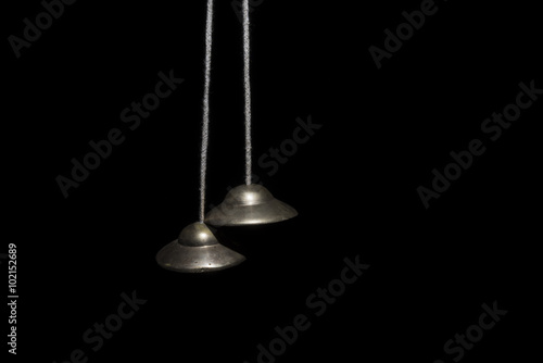 Hindu cymbals on black photo