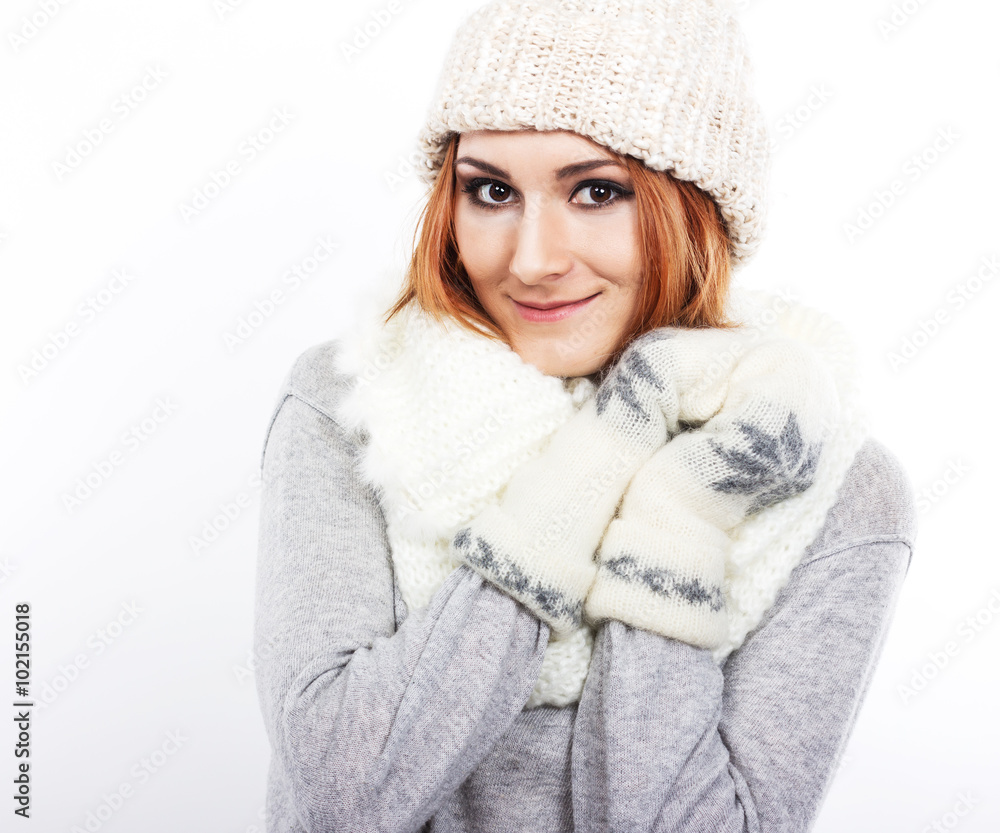 Young girl in a woolen hat and scarf. A girl dressed warmly. Winter cold. Portrait of a girl with big eyes on a white background
