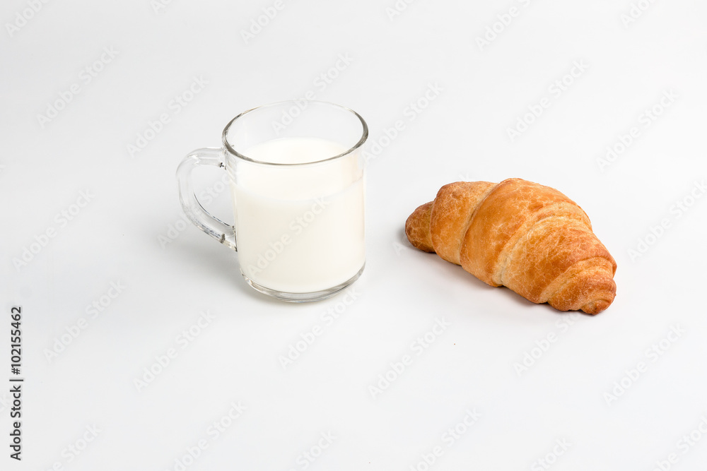 Glass cup with milk and croissant Glass cup with milk and croissant