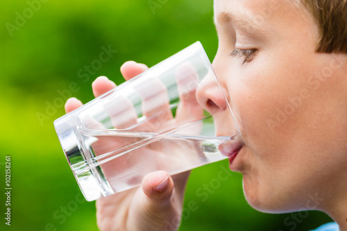 Child drinking glass of fresh water