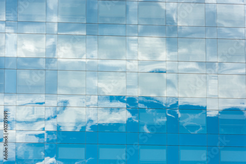blue sky and clouds reflected in office building