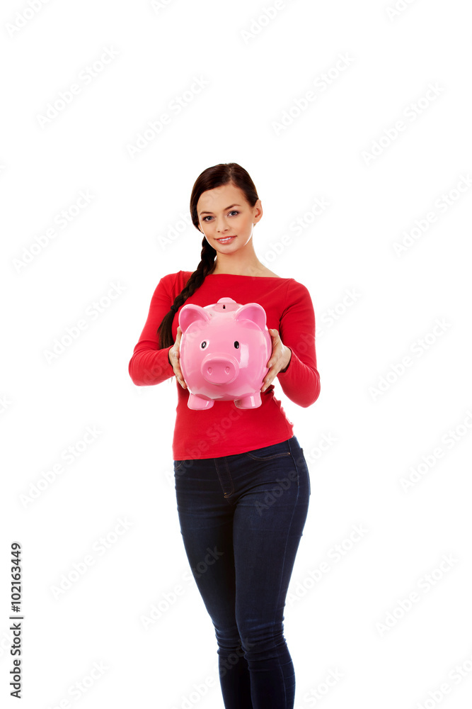 Happy young student woman holding piggybank Happy young student woman holding piggybank