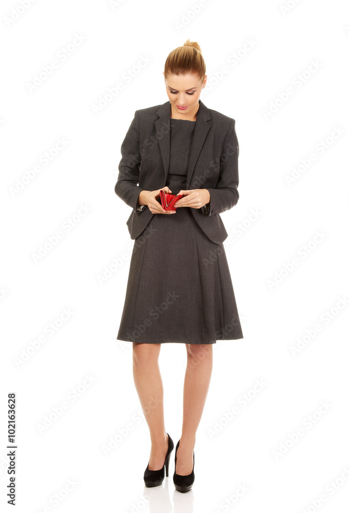 Worried business woman looking into her empty wallet Worried business woman looking into her empty wallet