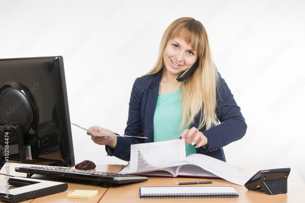 Business woman talking on the phone and looking for the desired paper documents Business woman talking on the phone and looking for the desired paper documents