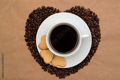 Hearts shaped coffee beans, cookies and a cup of coffee