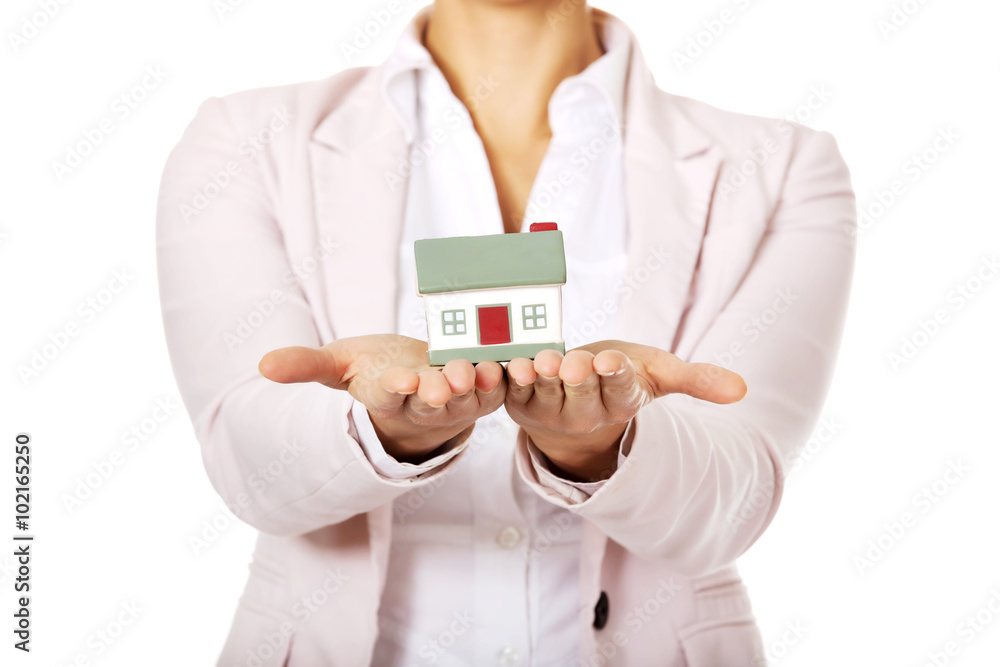 Business woman holding a house model Business woman holding a house model