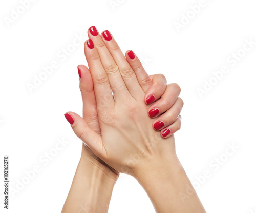 Women's hands with red nail polish.