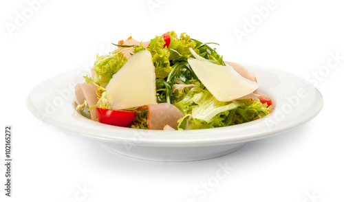Vegetable salad with ham, parmesan cheese and cherry tomatoes.