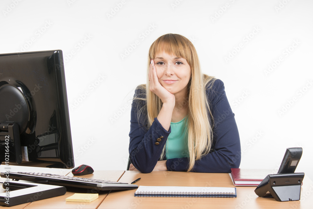 A little bit tired business woman behind a desk A little bit tired business woman behind a desk