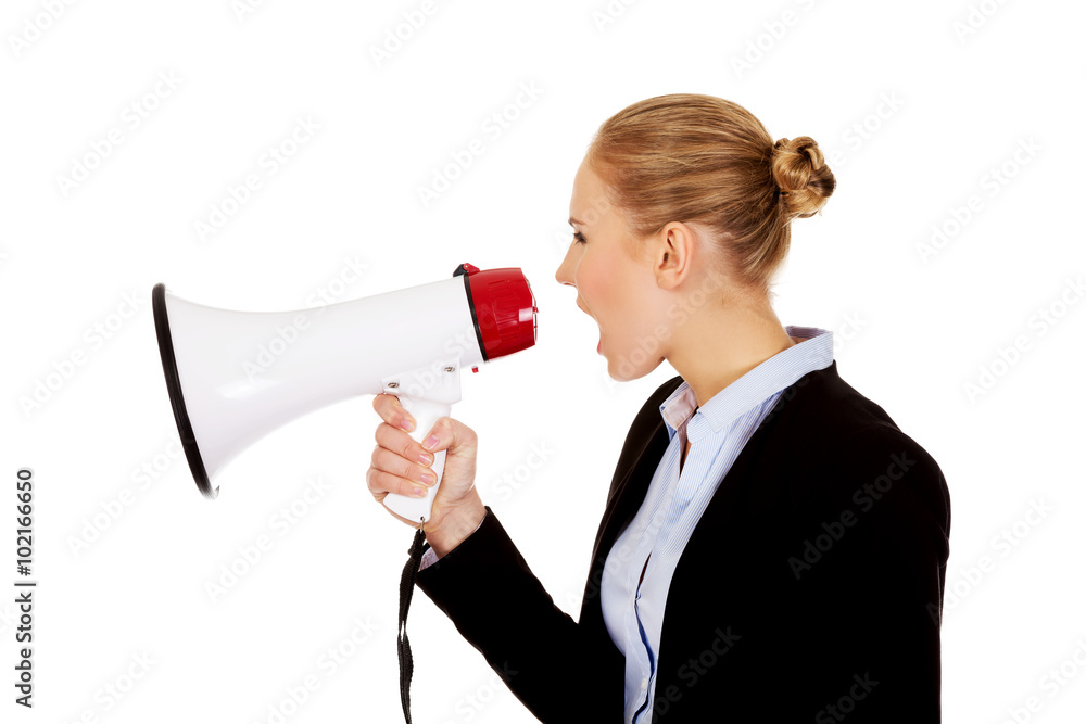 Young business woman screaming through megaphone Young business woman screaming through megaphone