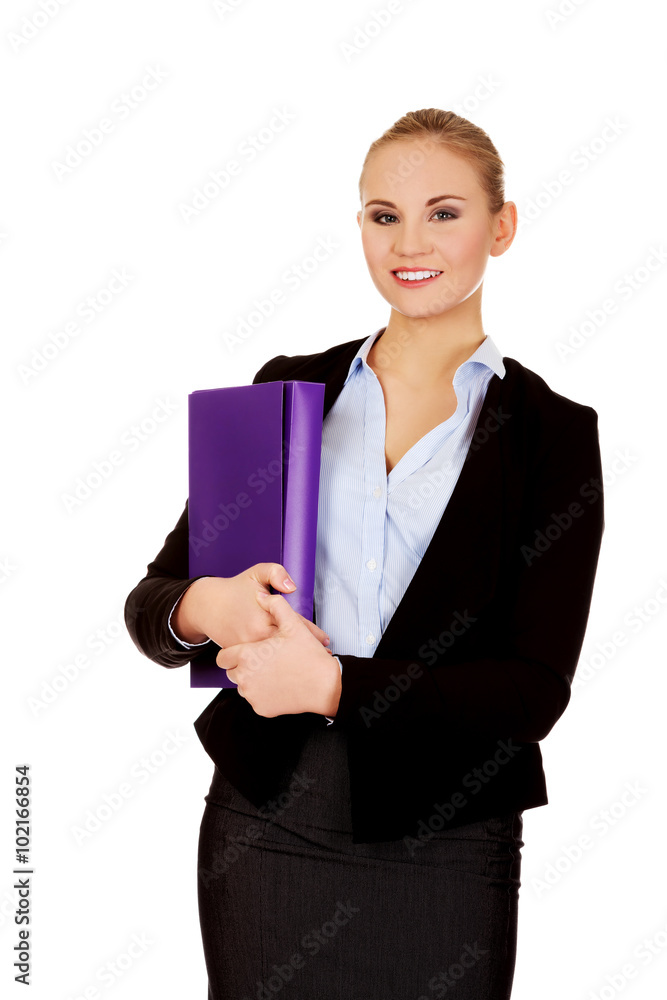 Smiling business woman holding a binder Smiling business woman holding a binder