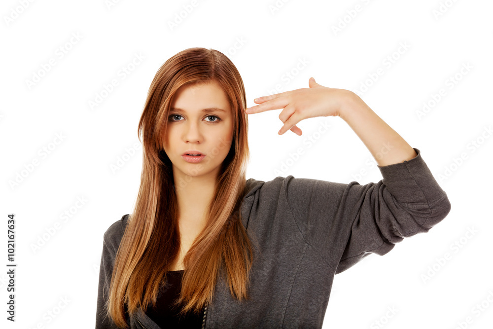 Teenage woman committing suicide with finger gun gesture Teenage woman committing suicide with finger gun gesture