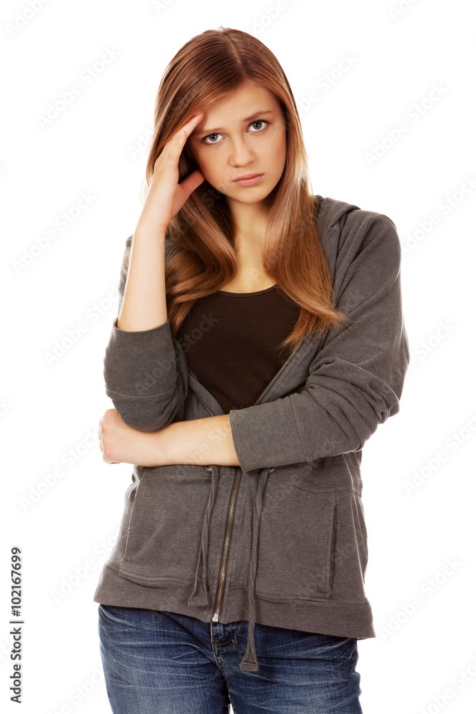 Worried teenage woman with folded arms Worried teenage woman with folded arms