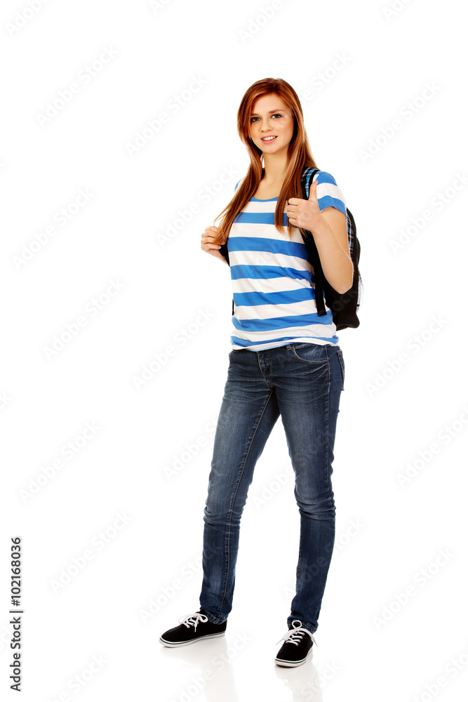 Happy schoolgirl with backpack and thumb up Happy schoolgirl with backpack and thumb up