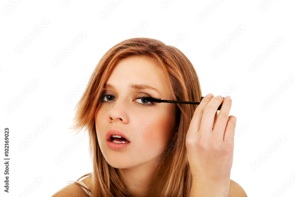 Teenage beautiful woman applying mascara Teenage beautiful woman applying mascara