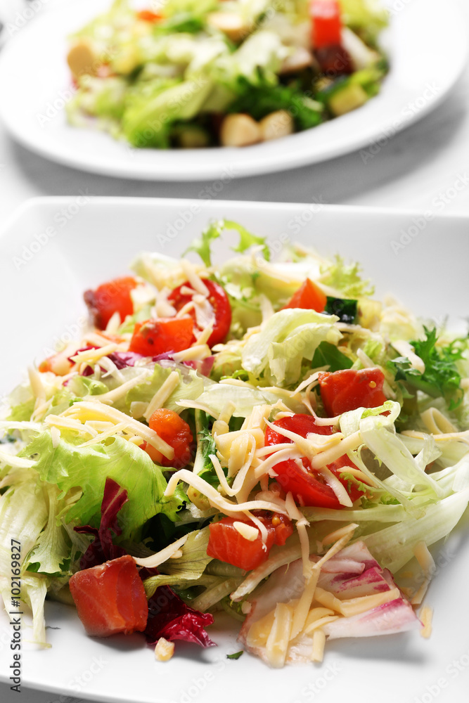Tasty salmon salad on wooden table background