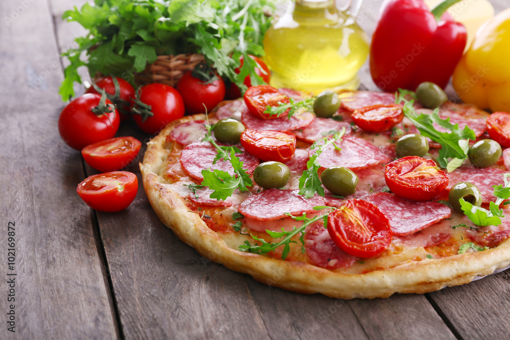 Delicious tasty pizza with ingredients on table, closeup Delicious tasty pizza with ingredients on table, closeup