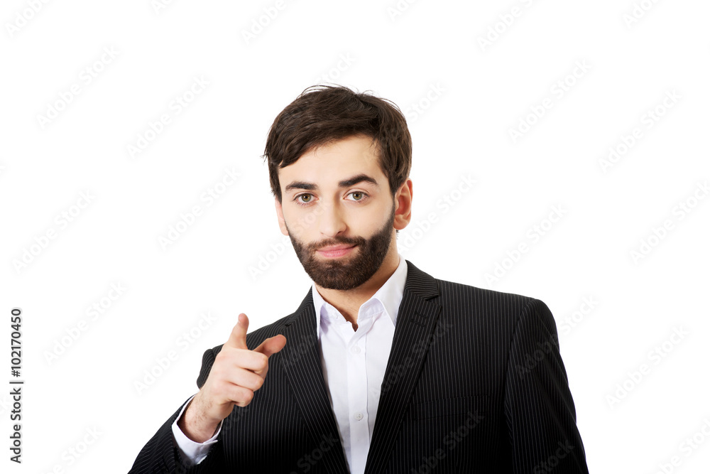 Happy businessman points his finger on you. Happy businessman points his finger on you.