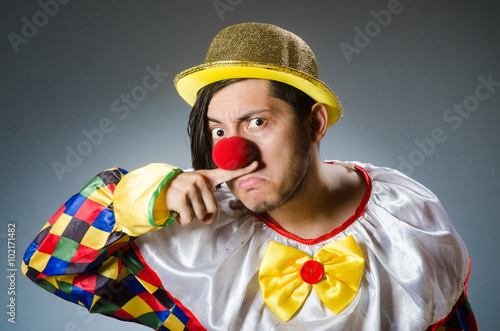 Funny clown against dark background