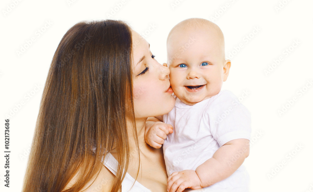 Portrait happy mother kissing her cute baby over white backgroun Portrait happy mother kissing her cute baby over white backgroun