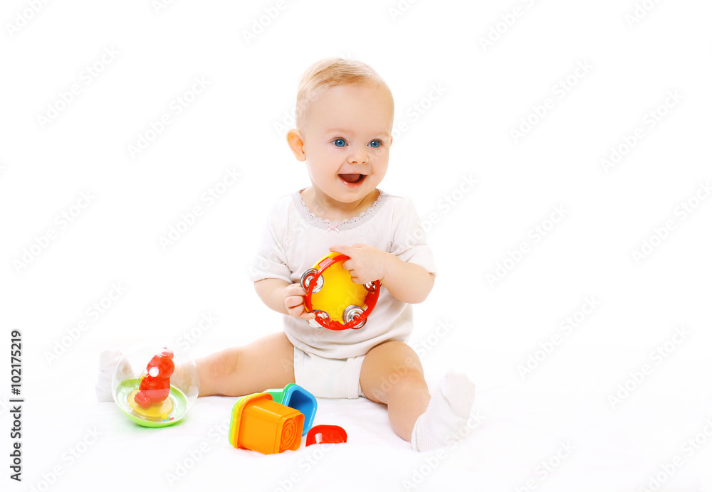 Happy smiling baby playing with toys on white background Happy smiling baby playing with toys on white background