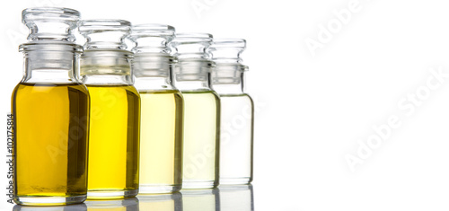 Avocado fruit oil, sesame seed oil, olive oil, grape seed oil and corn oil in vial glass bottle over white background
