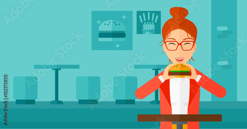 Woman eating hamburger. 