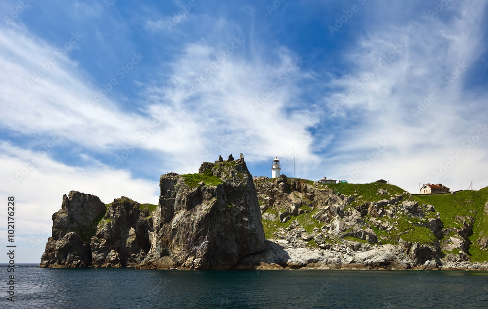 Naklejka premium Lighthouse on a steep cliff of Cape Gamow.