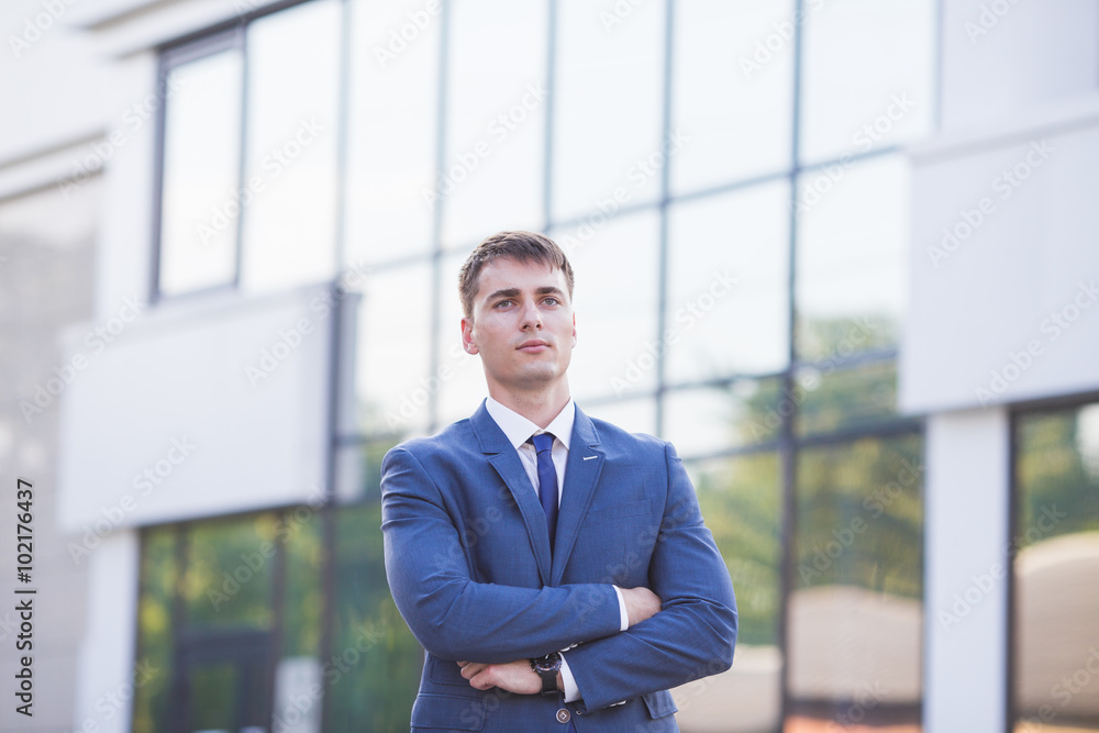Portrait of a young businessman standing over blurred background Portrait of a young businessman standing over blurred background