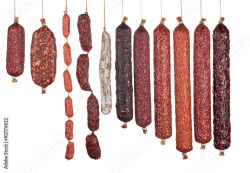 large variety of vertically arranged salami sausages isolated